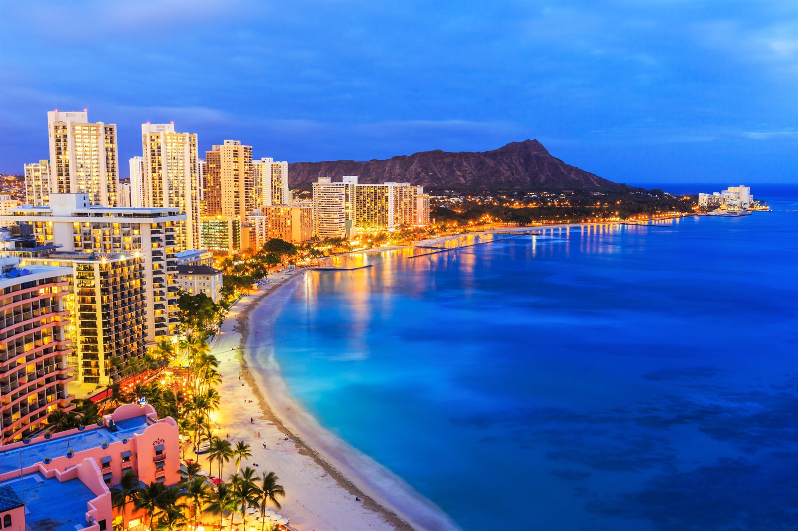Waikiki Beach, its hotels and Diamond Head at dusk on Oahu, often the best Hawaiian island for seniors on a first visit