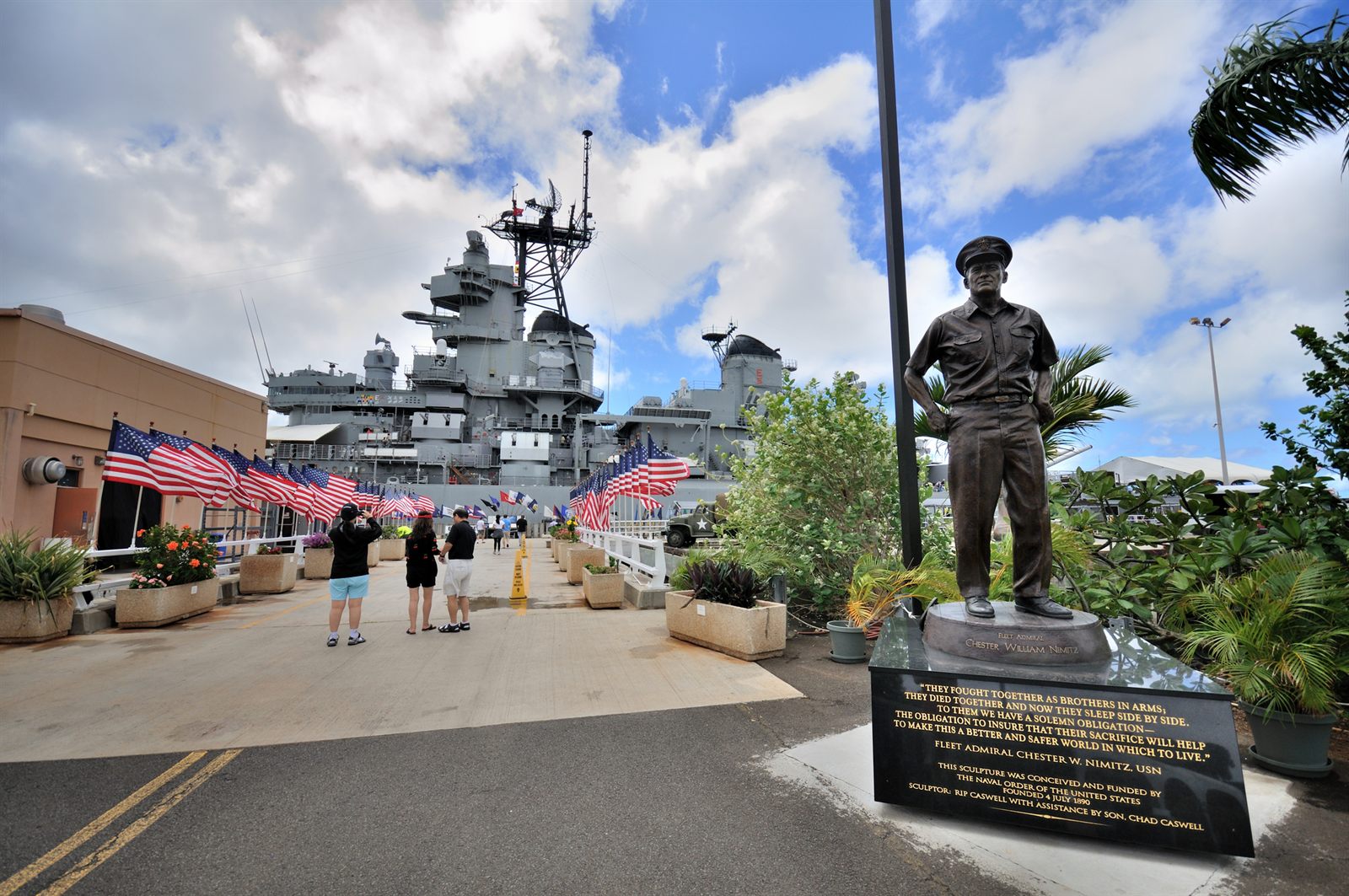 Visitors on the paved walkway to the Battleship Missouri at Pearl Harbor, a level stop on many Hawaii tours for seniors